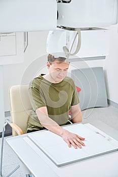 Adult patient is undergoing upper limb radiography photo