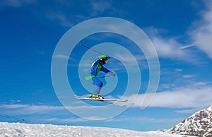 Male skier jumps in snow park against the blue sky. Livigno, Italy