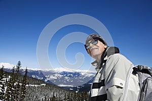 Male skier in mountains.