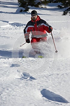 Male skier in powder