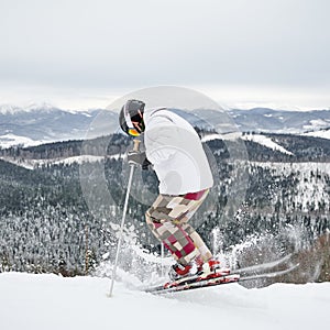Male skier skiing in beautiful winter mountains.