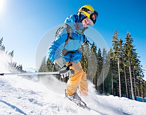 Male skier skiing on fresh snow in the mountains on a sunny beautiful day