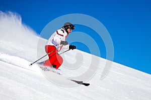 Male Skier Speeding Down Ski Slope