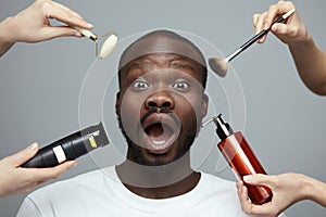 Male Skin Care Routine. Facial Beauty Treatment For African Model. Jade Roller, Electric Razor, Makeup Brush And Liquid In Bottle.