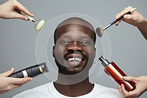 Male Skin Care Routine. Facial Beauty Treatment For African Model. Jade Roller, Electric Razor, Makeup Brush And Liquid In Bottle.