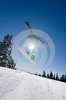Male Snowboarder Catches Big Air.