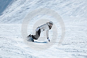 Male snowboarder gliding down a picturesque mountain covered in fresh snow