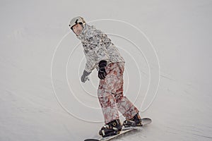 Male snowboarder at a ski resort in winter
