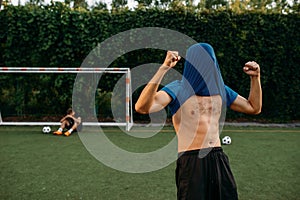 Male soccer player hits the goal on the field