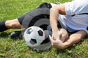 Male Soccer Player Suffering From Knee Injury photo