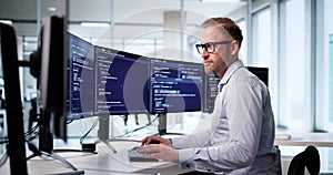 Male Software Engineer Coding At Office Computer Screen