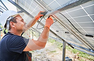 Male solar technician mounting photovoltaic solar panels.