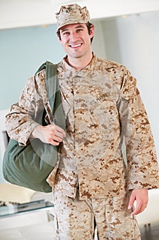 Male Soldier With Kit Bag Home For Leave