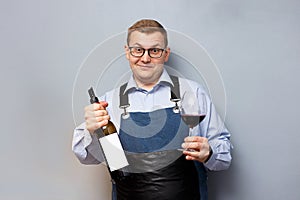 Male sommelier is checking and testing red wine