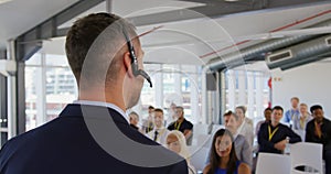 Male speaker with headset microphone addressing the audience at a business seminar