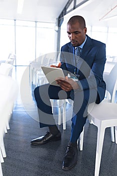 Male speaker practicing his speech on digital tablet in business seminar