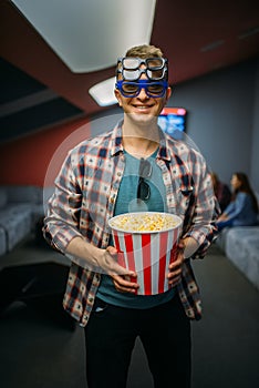 Male spectator in 3d glasses, cinema hall