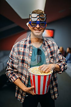 Male spectator in 3d glasses, cinema hall