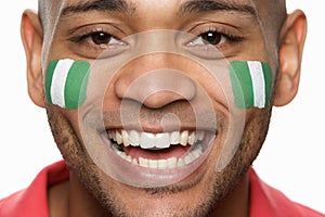 Male Sports Fan With Nigerian Flag Painted O photo