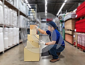 Male staff and parcel boxes checking stock and Blurred the background of the warehouse