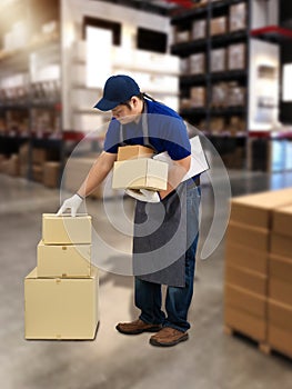 Male staff and parcel boxes checking stock and Blurred the background of the warehouse