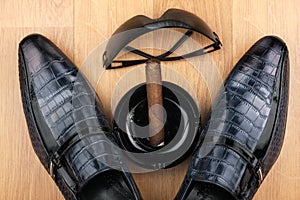 Male still life, classic men's shoes and a cigar in an ashtray