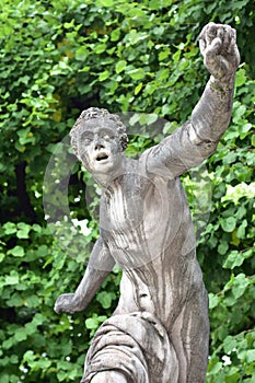 Male stone statue in park