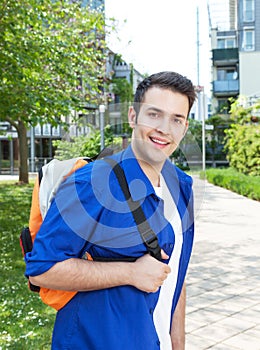 Male student on campus looking at camera
