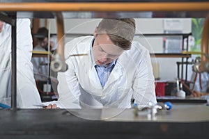 Male student of chemistry,pharmacy and biochemistry.Young scientist researcher examining experiment.Blonde male Scandinavian young