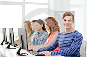 Male student with classmates in computer class