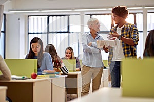 Male student discussing the lesson with female professor