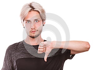 Male student giving thumb down