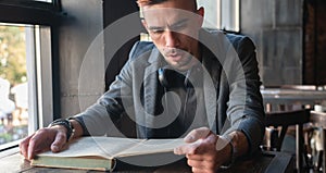 Male student hipster reading a book. Knowledge, education, development concept. Horizontal image