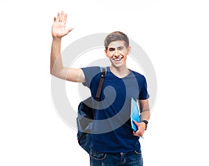 Male student holding folder and showing greeting gesture