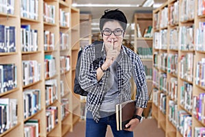 Male student making silence sign