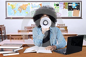 Male student with a megaphone in the classroom