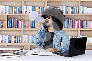 Male student with megaphone in the library