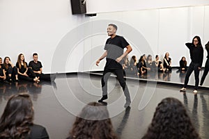 Male Student At Performing Arts School Performs Street Dance For Class And Teacher In Dance Studio