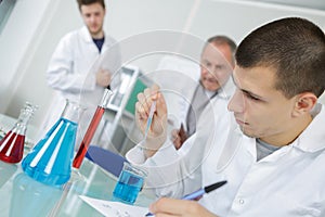 Male student performing science experiment