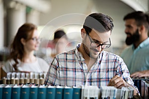 Male student picking a book in a library