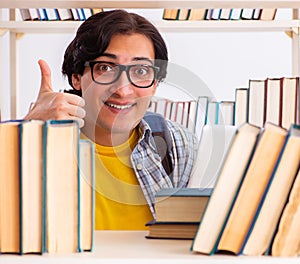 Male student preparing for exams at library