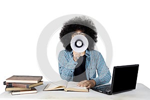 Male student shouting by using a megaphone