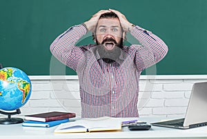 male student sit in school classroom while hard lesson. pass the exam. learning is hard. stressed hipster teacher