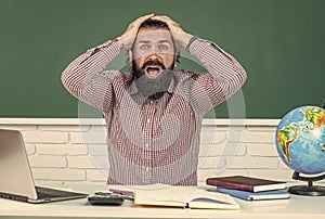 male student sit in school classroom while hard lesson. pass the exam. learning is hard. stressed hipster teacher