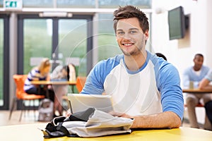 Male Student Studying In Classroom With Digital Tablet