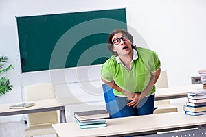 The male student suffering from urge in the classroom photo