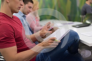 Male student taking notes in classroom