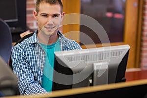 Male student using computer in the computer room