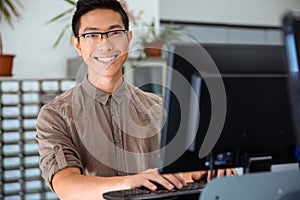 Male student using personal computer in university