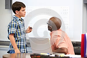 Male Student Writing Answer On Whiteboard